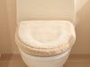 Create a cozy image of 'SnuggleSeat Toilet Lid Cover' with plush texture, warm colors, luxurious bathroom decor., vector, best quality, masterpiece